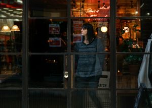 woman standing near glass window